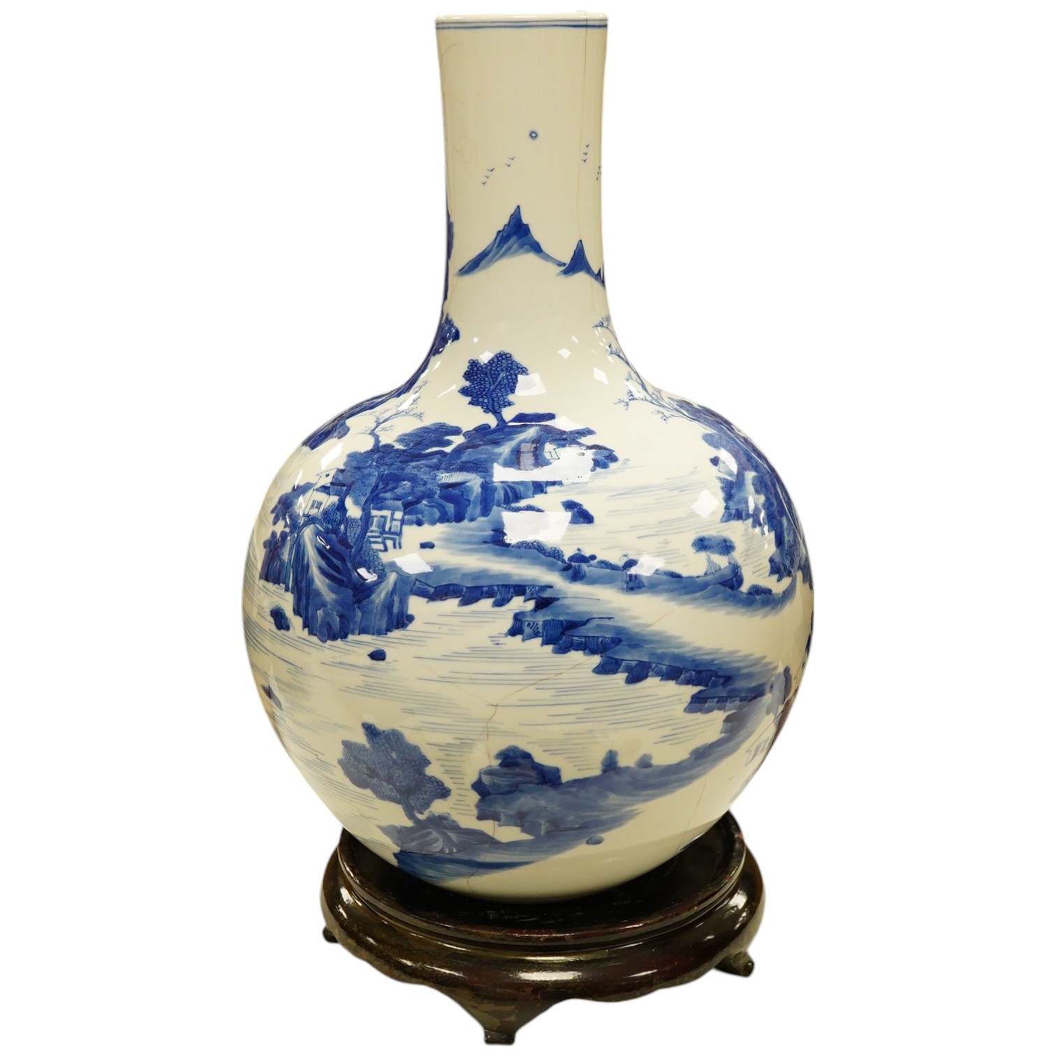 A Chinese blue and white bottle vase decorated with a landscape, 47cm high. Condition - poor